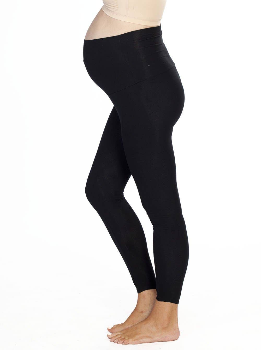 A pregnant woman in black maternity leggings with an over-the-bump style