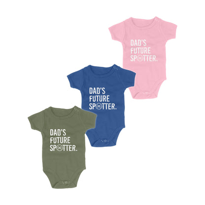 Three baby bodysuits in green, blue, and pink with 'Dad's Future Spotter' text on a white background.