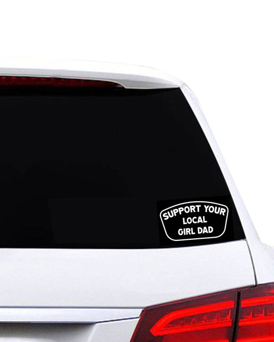 Car window with a decal reading 'Support Your Local Girl Dad' on a white background