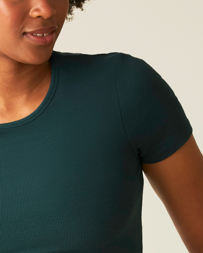 Person wearing a dark green t-shirt against a neutral background