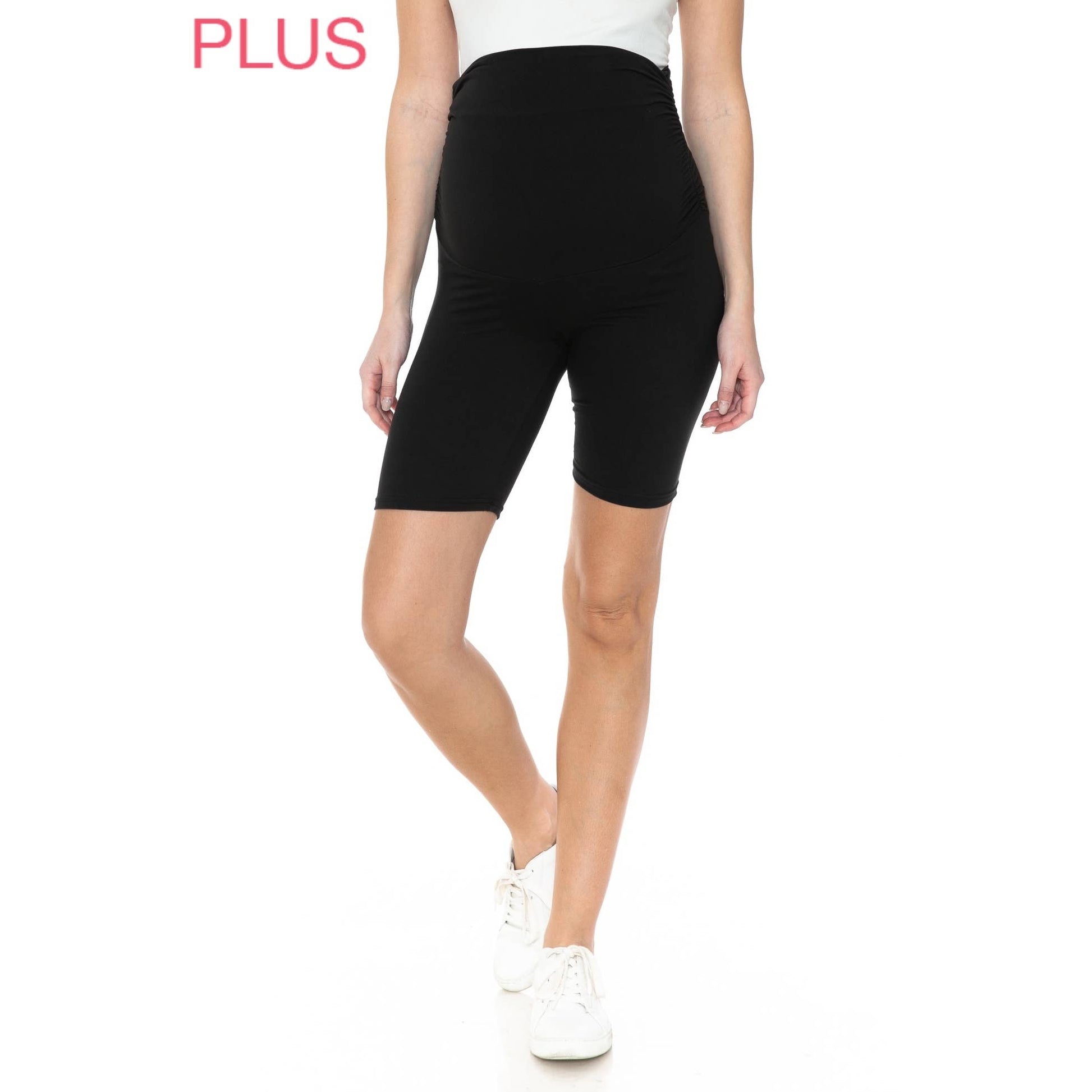 A pregnant woman in Plus Size Buttery Soft Print Maternity Shorts in the color black.