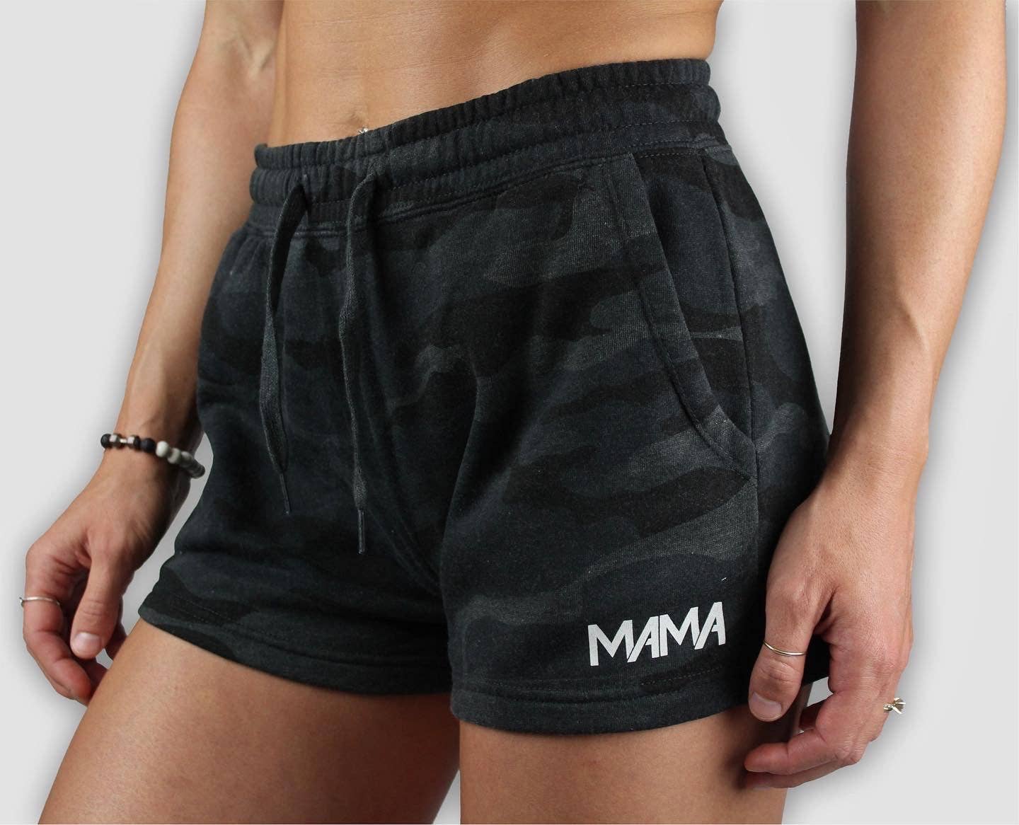 Black camouflage shorts with 'MAMA' text on a white background