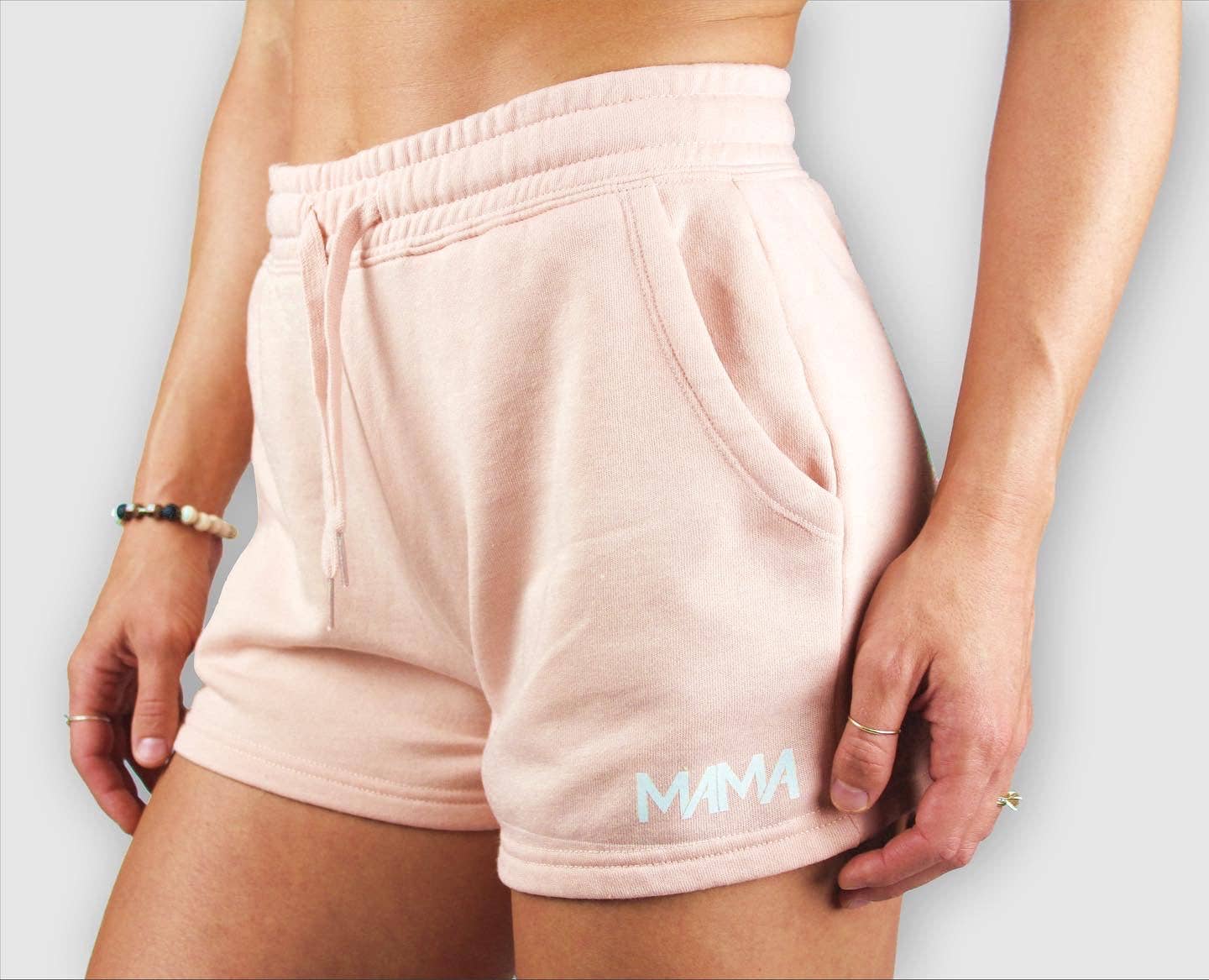 Pink shorts with 'MAMA' branding on a plain background