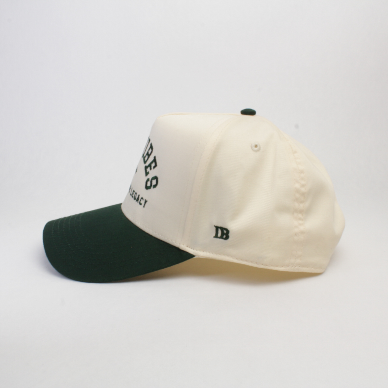 Side wiew of a green and white cap against a white background