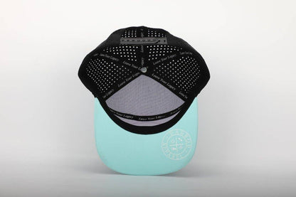 Black and teal cap with a brand logo on a light gray background