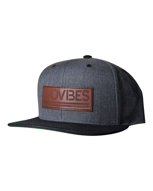Gray cap with a brown leather patch displaying DADVIBES' on a white background