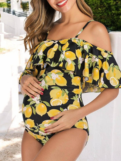 Pregnant woman wearing a black off-shoulder top with lemon print in an outdoor setting