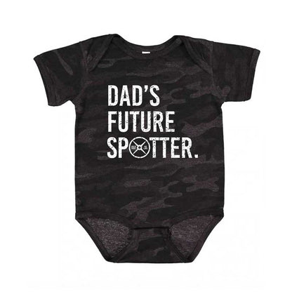 Black camouflage baby onesie with 'Dad's Future Spotter' text on a white background