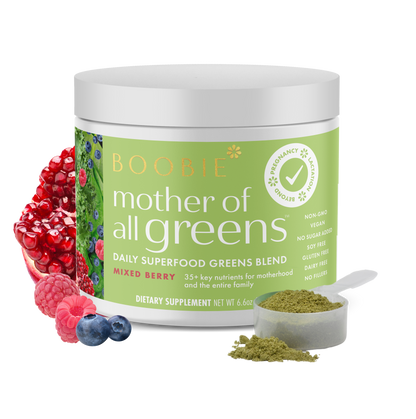 A tub of Boobie Superfoods Mother of All Greens powder in the Mixed Berry flavor with a scoop of the powder and fruits around it.