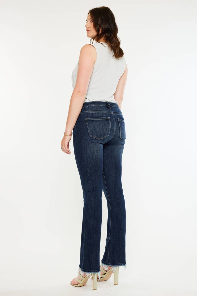 Pregnant woman wearing blue jeans on a white background